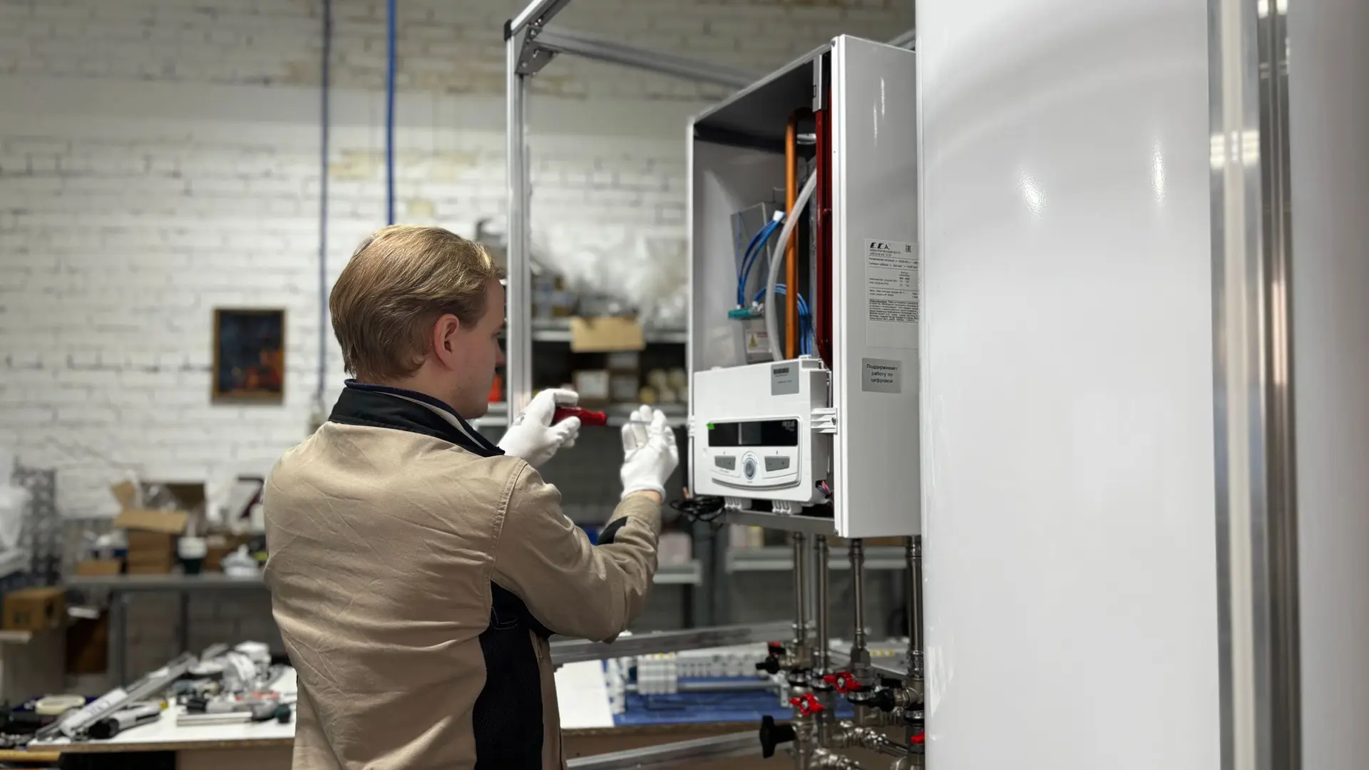 Engineer working on a wall-mounted boiler