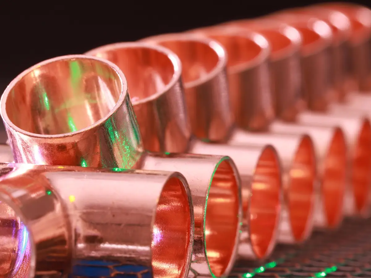 Row of copper pipe fittings