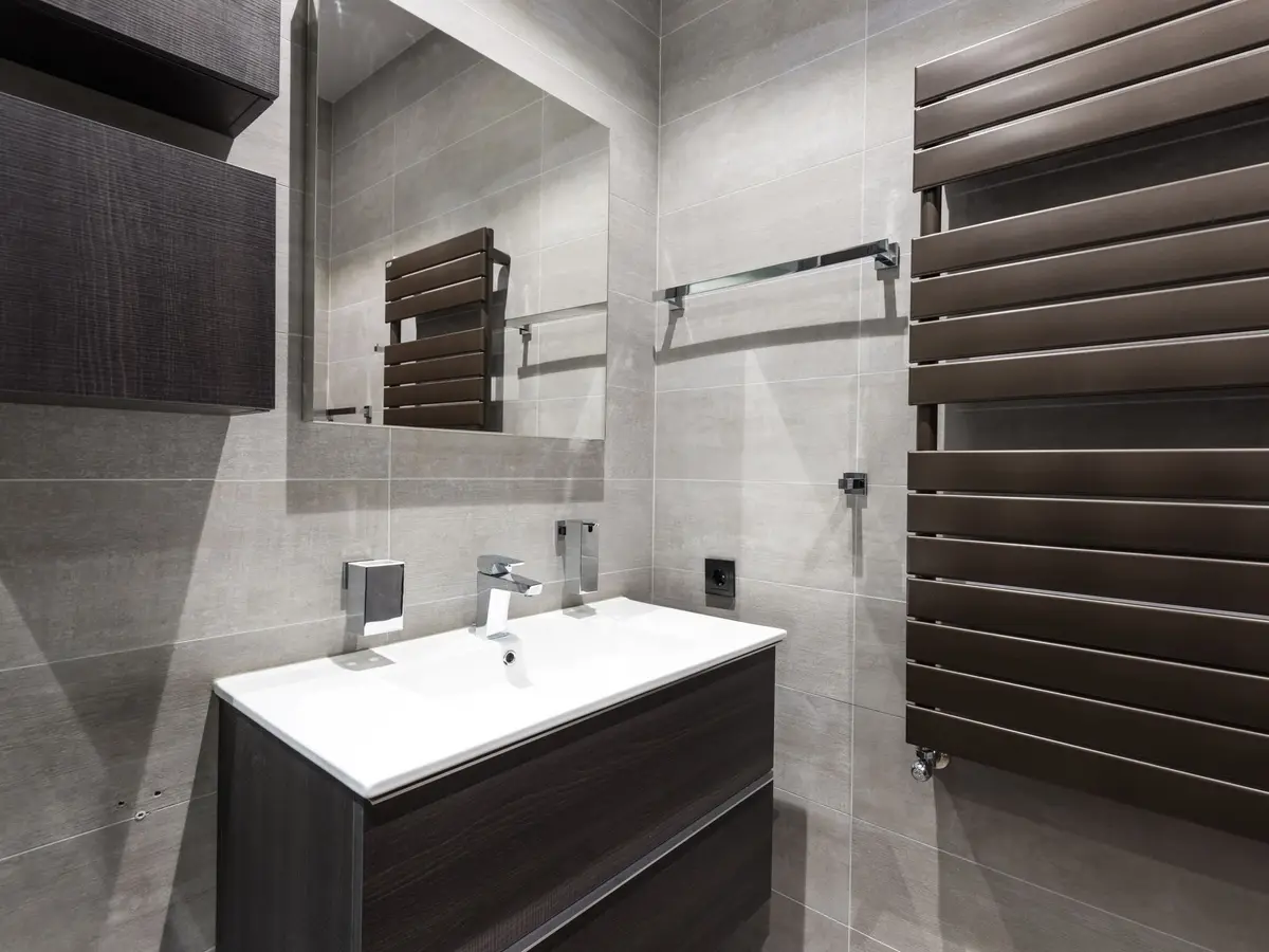 Bathroom with a dark towel radiator and wall-hung vanity