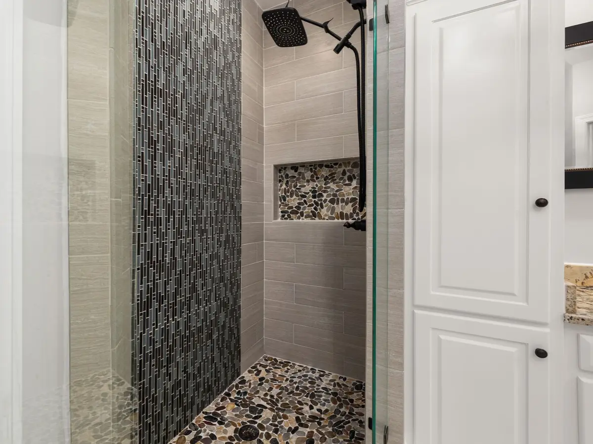 Tiled shower recess with a mosaic feature strip